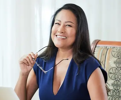 A young business professional sitting at her desk